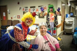 PAINTING SMILES - Brian Bassham of Boyd filled the role of Santa and clown ally to perform with his mother, Carolyn, after his dad, Alvin, died in May. Messenger photo by Joe Duty