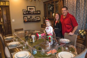 TABLE TALK - Jesica McEachern's unique dining room table - which features an HO scale train and miniature city - preserves memories of her teen years with her extended family - parents, sisters, nieces and nephews. Now that she has it at her home in Alvord, she's excited for the memories it will preserve of her smaller family. Messenger photo by Joe Duty