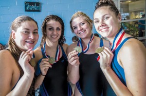 ALL SMILES - Decatur's Haley Dennard, Madeleine Semmelmann, Katey Rowden and Baley Phariss show off their third place medals from the 200 medley relay. Messenger photo by Joe Duty