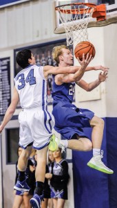 AND ONE - Decatur's Cain Lowe connects after picking up the foul against Krum Friday. Messenger photo by Joe Duty