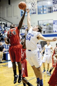 BLOCK PARTY - Decatur's Shayler Carlton blocks a shot from Gainesville's Denzel Johnson Tuesday. The Leopards rallied for a 40-36 victory. Messenger photo by Joe Duty