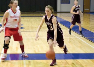 HAPPY ENDING - Bridgeport's Cheyenne Davidson dribbles around the defense during the NCTC Holiday Classic. The Sissies defeated Sacred Heart 51-48 for the consolation championship. Messenger photo by Clay Corbett