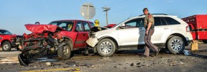 LOW VISIBILITY - Limited visibility due to a line of 18-wheelers parked alongside the road might have caused two SUVs to collide at the intersection of Farm Roads 51 and 2123 Tuesday morning. Both drivers were taken to a local hospital with minor injuries. Messenger photo by Joe Duty
