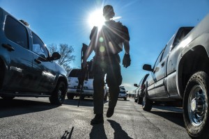 PEACEFUL FINISH - Jason McCall, a member of the Wise County Sheriff's Office SWAT team, patrols an area near after a standoff that lasted for a couple hours at a home near the Bridgeport Municipal Airport. Messenger photo by Joe Duty