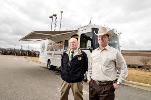 READY TO ROLL - Captain Kevin Benton (left) and Sheriff David Walker stand outside the county's new mobile command post parked in front of the Sheriff's Office last week. The state-of-the-art vehicle will be used as a communication base at the site of extended emergencies. Messenger photo by Joe Duty