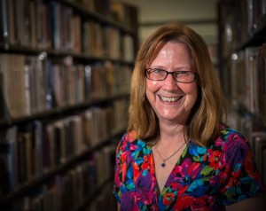 STANDING IN THE STACKS - Pat Peters of Denton is settling in at the Decatur Public Library this week. The city recently hired Peters as library director, replacing Cecilia Barham who resigned in October. Messenger photo by Joe Duty
