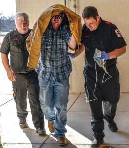 TAKEN AWAY - Jimmy Warden, 43, of Bridgeport, is taken to the emergency room at North Texas Community Hospital in Bridgeport after he turned himself over to authorities for allegedly making a terroristic threat and aggravated assault and creating a standoff situation. Messenger photo by Joe Duty