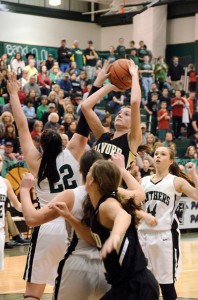 CROWDED LANE - Alvord's Marissa Schedcik goes up for the shot as Paradise's Makenna Burt looks for the block. Messenger photo by Mack Thweatt