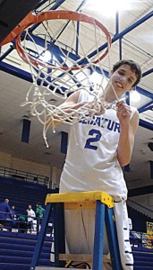 NICE FINISH - Decatur's Phillip Walker helps cut down the net after the Eagles district championship clinching win over Krum. Messenger photo by Jimmy Alford