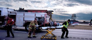UP IN THE AIR - Emergency responders prep Larry Givens, 69, of Dallas, for transport in a helicopter bound for John Peter Smith Hospital Monday. Messenger photo by Jimmy Alford
