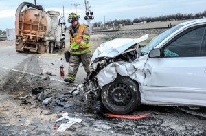 WRECK SCENE - A firefighter surveys the damage following an accident at Texas 114 and County Road 3241 near Paradise Monday morning. Toby Baker, who was driving the white Hyundai Elantra, later died at Wise Regional Health System in Decatur. Messenger photo by Joe Duty