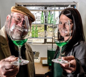 GLASS PRISM - Winemakers Les Constable and Rachel Cook show off a sample of the green wine made with Blanc du Bois grapes. Messenger photo by Joe Duty