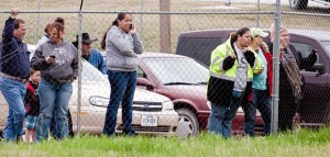 WITNESSES - Onlookers stare at the scene of Ebel's fiery crash from the parking lot of a local government building. Messenger photo by Jimmy Alford