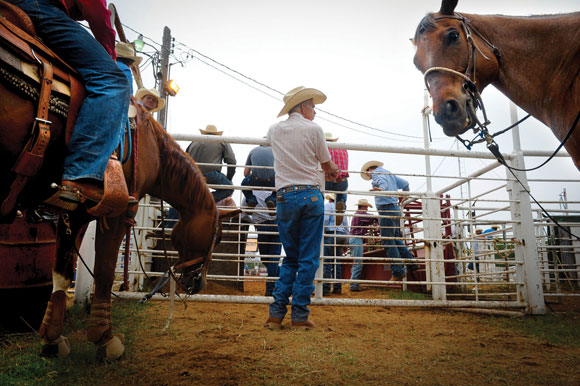 OF HORSES AND MEN - Jim Allsup of Decatur checks out the riders on deck during Thursday's slack round. Messenger photo by Joe Duty