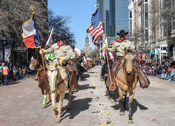 RIDING FOR WISE - Wise County Sheriff's Posse President Russell Stephens (left) and Cody Burgett lead other Posse members in the Fort Worth Stock Show and Rodeo (FWSSR) All Western Parade Saturday morning in downtown Fort Worth. More than 2,300 horses participated in the legendary event, which is the unofficial kickoff to the FWSSR. Messenger photo by Joe Duty