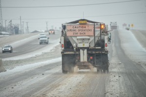 Trucks dump sand on highways Sunday to counter effects of slick roads caused by winter storm. Photo by Joe Duty.